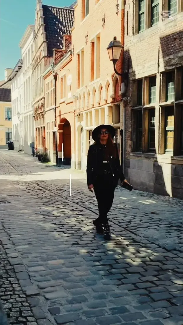 Nandy walking a cobbled street in Bruges